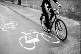 The Stylish Cyclist contemporary black and white photograph of bicycle on marked street.