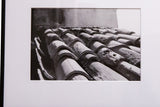 Angled view of the terracotta roof print in a black frame with wide white matting.