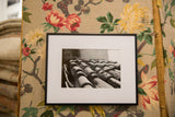 Professionally framed black and white photo of terracotta roof tiles with a wide white mat.