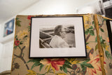 Black framed 'The Chatter' photograph, featuring a woman's profile with glasses.