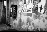 The Rebels black and white photograph depicting a distressed wall with urban posters.