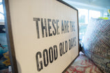 Angled close-up of the distressed black lettering on the wooden 