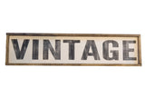 Vintage style sign with distressed black 'VINTAGE' lettering in a dark wood frame.