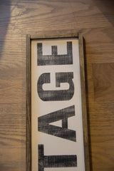 Angled view of the vintage style sign's textured lettering and wood frame.