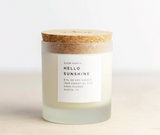 Hello Sunshine soy candle in frosted glass with white label and cork lid.