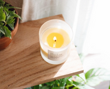 Lit wick and bright yellow melting wax of the Hello Sunshine soy candle.