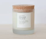 Slow North Orange and Clove Soy Candle in frosted glass with a natural cork lid.