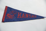 Vintage Kansas University felt flag with vibrant red Jayhawk and KANSAS graphic on blue.