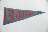 Aged blue felt and red graphic elements of the vintage Houston Oilers pennant.