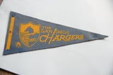 Close-up of vintage San Diego Chargers felt pennant corner with visible pinhole and texture.