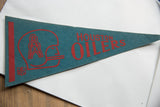 Red Houston Oilers lettering on teal felt pennant, with helmet logo and light creasing.