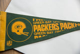 Green felt texture of a vintage Green Bay Packers pennant with minor pinholes.