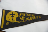 Vintage New Orleans Saints black felt pennant detail, gold helmet, fleur-de-lis, and NFL logo.