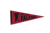 Vintage 1970s Atlanta Falcons felt pennant in red with black team logo and text.