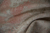 Distressed vintage Oushak rug close-up, with worn pale pink and beige pile revealing faint foundation.