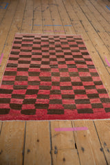 Distressed vintage Tulu rug with nuanced cherry red and chocolate brown checkerboard and textured abrashes.