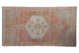 Distressed vintage Oushak rug with hexagonal medallion, dusty rose, and oxidized silver colors. 2'11