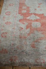 Distressed pile texture with faded brick red leaf outlines and starbursts on an ivory ground.