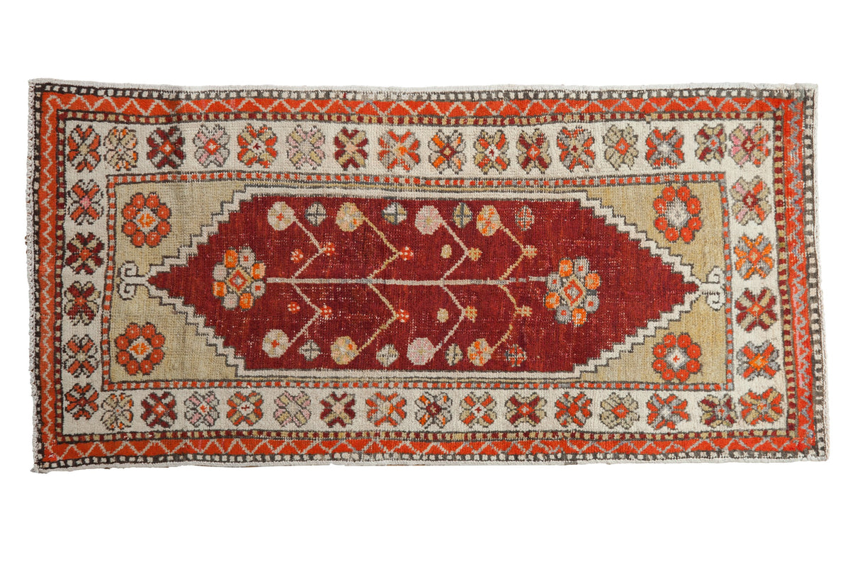 Distressed vintage Oushak runner with a red tree of life medallion and decorative orange floral borders.