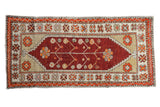 Distressed vintage Oushak runner with a red tree of life medallion and decorative orange floral borders.