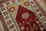 Dusty saffron spandrels meet the cherry red field's tree of life motif.