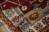 Textured hand-knotted pile of a distressed Oushak runner with saffron and tangerine floral buds.