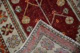 Folded corner of a vintage Turkish Oushak revealing its hand-knotted foundation and original selvage.