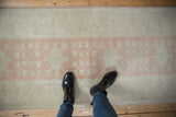 Distressed vintage Oushak runner with dusty pink quatrefoil guls and ivory field.