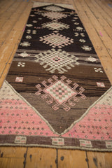 Pale pink and ivory geometric medallion of a distressed vintage Kars runner.