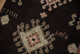 Woven partial date and primitive geometric pattern on a distressed Kars rug runner.