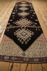 Vintage distressed Kars runner bottom end, showing aubergine border and textured ivory pile.