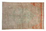 Vintage distressed Oushak rug, faded green medallion, floral motifs on abrashed beige, 5' x 7'7