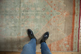 Soft, sun-faded pile of a distressed Oushak rug in seafoam green and beige.