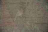 Textured, sun-faded pile of vintage Oushak rug, showing soft green and muted red.