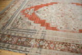 Distressed meandering vine and lotus border with abrashed sand and brown tones.