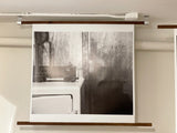 Black and white print displaying faint 'Socrates' text on the background wall.