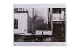 Black and white contemporary photograph print, 'Home Sweet Home,' featuring a safe and model train.