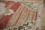 Distressed Oushak rug with heavily abrashed cherry red and pale bronze stripes and stepped contour.