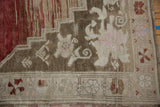 Detail of distressed Oushak carpet border with floral motifs and even wear.