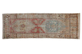 Distressed vintage Oushak rug runner with faded double medallions in cherry red and ocean green.