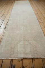 Distressed vintage Karaja runner pile, showing soft pale pink, ivory, dusty green patterns.