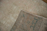Vintage distressed Karaja runner: worn pile and geometric patterns on its hand-knotted reverse.