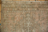 Distressed Karaja runner detail showing even wear, serrated geometric motifs, pale blush.