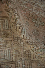 Distressed Karaja rug pile, showcasing even wear, soft blush, and coffee brown tones.