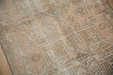 Distressed Karaja rug pile with worn pale blush, sand, and dusty blue hook motifs.