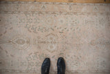 Standing on the distressed Sivas rug runner to show its time-softened texture and scale.