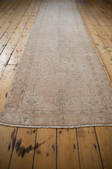 Perspective view of the entire distressed Sivas runner, revealing the low pile and faded floral pattern.