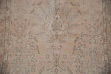 Close-up of a vintage Sivas rug's worn texture, detailing a lotus palmette and millefleur field.