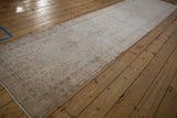 An angled, full-length view of the distressed Sivas runner, highlighting its pale pink and beige palette.