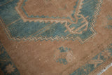 Distressed vintage Hamadan rug's textural pile, showing dusty turquoise and camel serrated geometric designs.